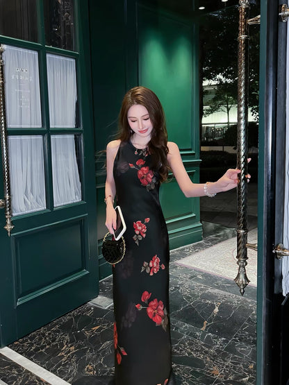 Stunning French-style black floral acetate camisole dress with a V-neck—a new summer arrival featuring a figure-flattering, slim-fit, and elegant long silhouette.