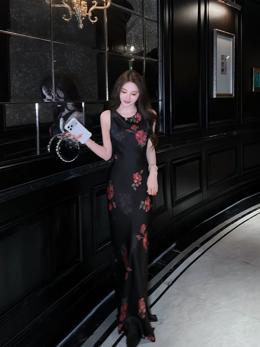 Stunning French-style black floral acetate camisole dress with a V-neck—a new summer arrival featuring a figure-flattering, slim-fit, and elegant long silhouette.