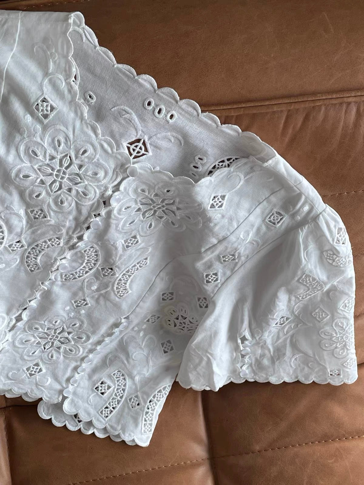 Women's Early Autumn Loose Short-Sleeve Shirt with Laser-Cut Embroidery, Button Detail, and Side Slits – Scalloped-Edge Top