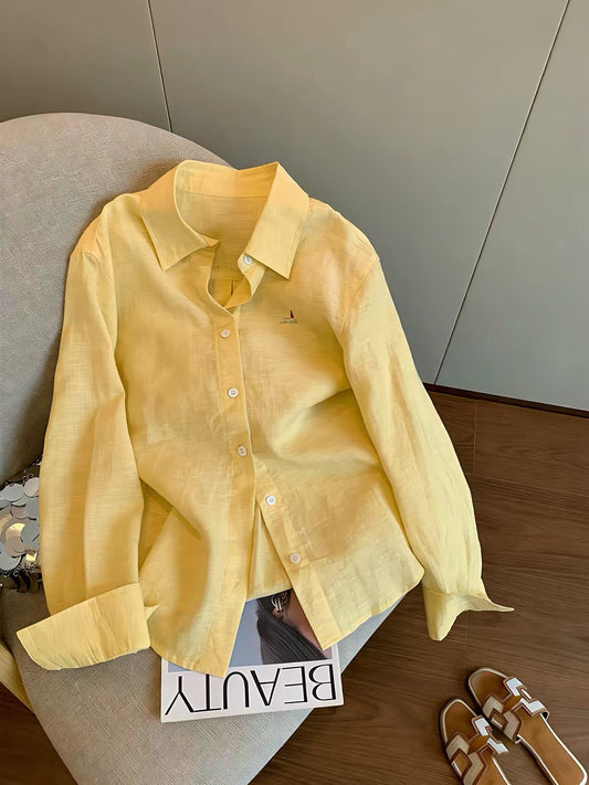 "Old Money" aesthetic: a minimalist yellow long-sleeved collared shirt for women, perfect for spring and autumn—featuring a relaxed, effortless, and loose fit that doubles as a light shirt-jacket.
