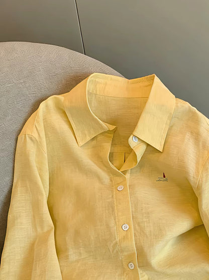"Old Money" aesthetic: a minimalist yellow long-sleeved collared shirt for women, perfect for spring and autumn—featuring a relaxed, effortless, and loose fit that doubles as a light shirt-jacket.