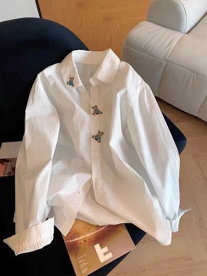 Japanese-style minimalist-chic long-sleeve shirt for women, featuring a cute cartoon bear, Polo collar, and a simple, loose, versatile design—perfect for spring and autumn.