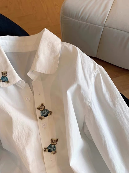 Japanese-style minimalist-chic long-sleeve shirt for women, featuring a cute cartoon bear, Polo collar, and a simple, loose, versatile design—perfect for spring and autumn.