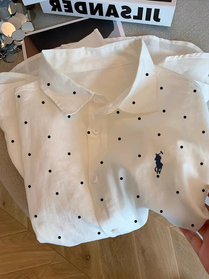 Women's French-style chic white polka-dot long-sleeve shirt with a polo collar; a lightweight, relaxed-fit piece suitable for summer as a shirt or light outer layer.