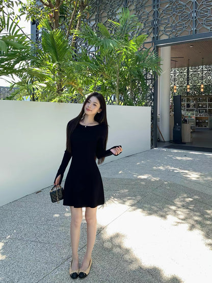 pusumede — A charming, fitted A-line knit mini dress featuring a French-style round neck and long sleeves; designed to flatter the waist and exude an elegant, alluring vibe.
