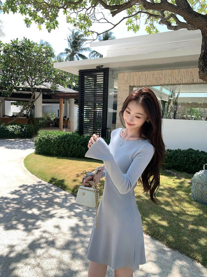 pusumede — A charming, fitted A-line knit mini dress featuring a French-style round neck and long sleeves; designed to flatter the waist and exude an elegant, alluring vibe.