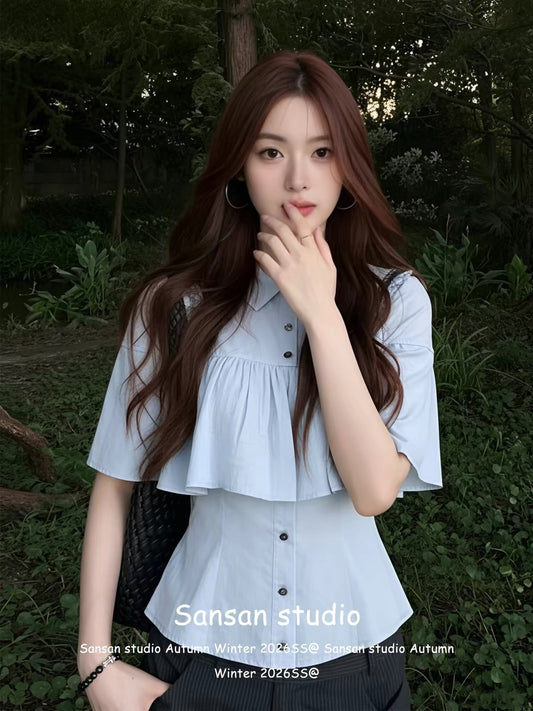 Korean-style blue short-sleeved shirt with a cape-style overlay—a chic, sophisticated summer top featuring a waist-cinching, slimming fit.