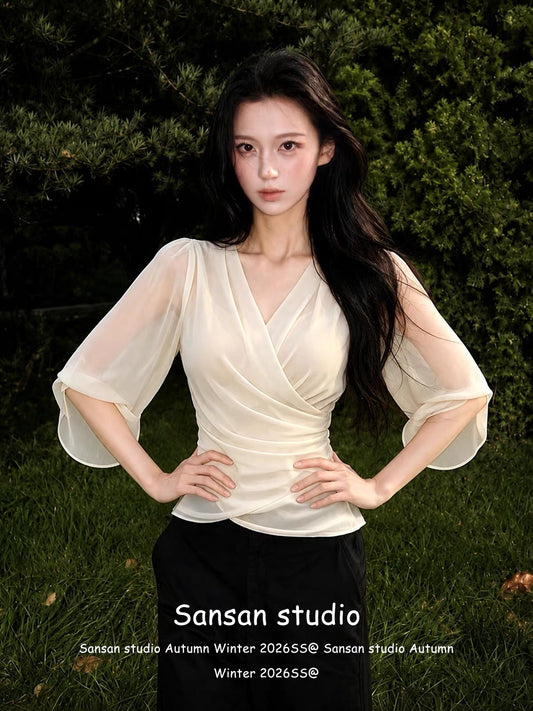 Women's French-style V-neck chiffon blouse with mid-length sleeves—a chic, waist-cinching, and slimming summer top that exudes an air of sophisticated, casual elegance.