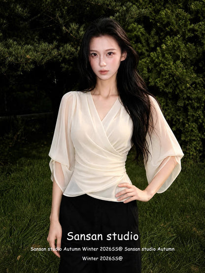 Women's French-style V-neck chiffon blouse with mid-length sleeves—a chic, waist-cinching, and slimming summer top that exudes an air of sophisticated, casual elegance.