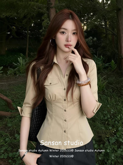 Korean-style fitted mid-sleeve shirt for women—a summer staple featuring a waist-cinching cut, pockets, and a classic collar; a slim-fit, flattering, and sophisticated top.