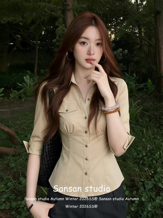 Korean-style fitted mid-sleeve shirt for women—a summer staple featuring a waist-cinching cut, pockets, and a classic collar; a slim-fit, flattering, and sophisticated top.