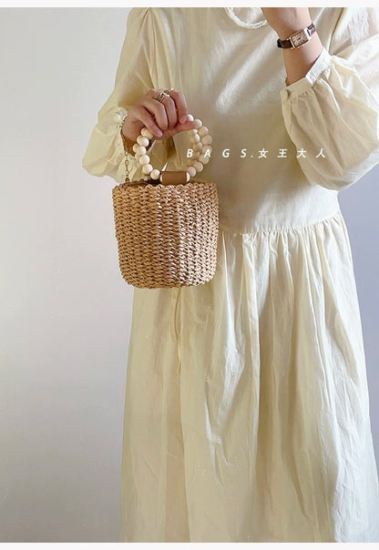 Beaded portable straw bag, hand-woven bag, round bag, small fresh and casual seaside beach handle bucket bag
