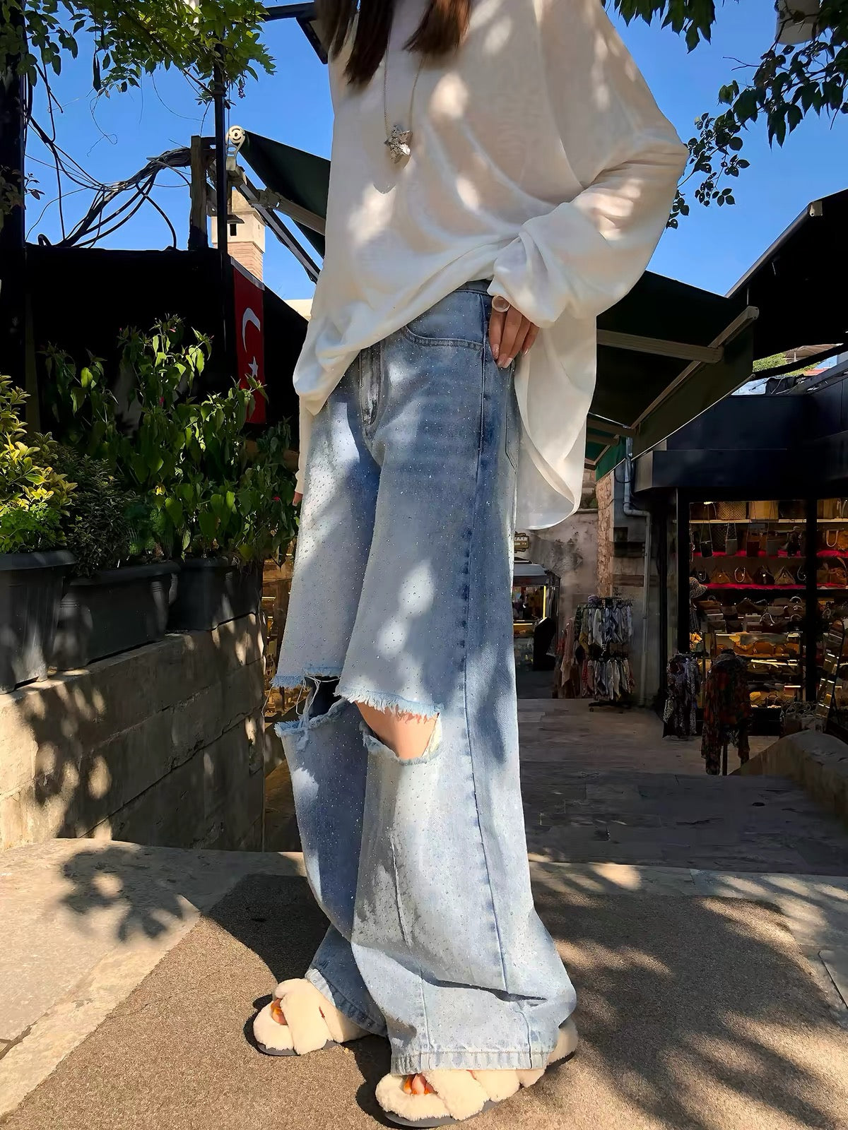 Li Wanjun "Galaxy Rhinestone Jeans" – High-quality denim featuring 78% cotton, intricate hot-fix rhinestone detailing, and distressed knee cutouts.