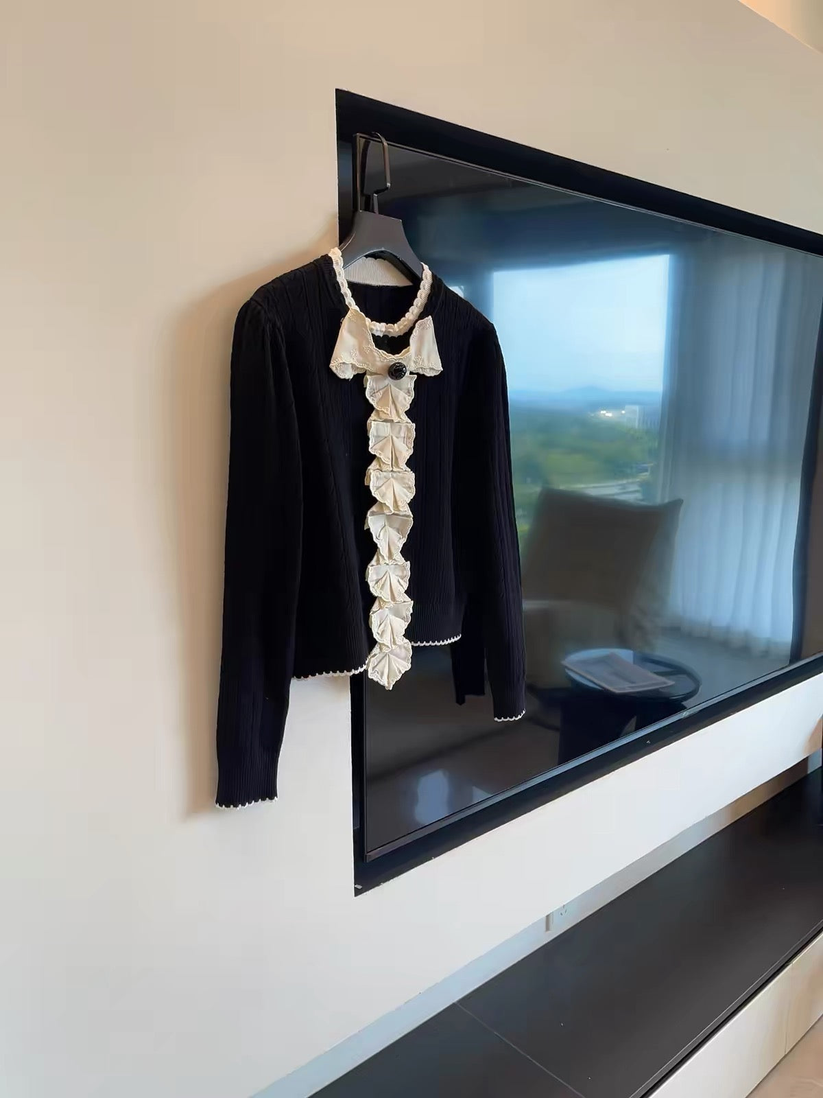 July Launch: Miu-inspired "heiress aesthetic" — black long-sleeve knit cardigan featuring intricate embroidery and a detachable bow.