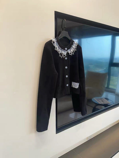 Miu-style luxe aesthetic: Black long-sleeved knit cardigan featuring intricate bead and tassel embellishments.