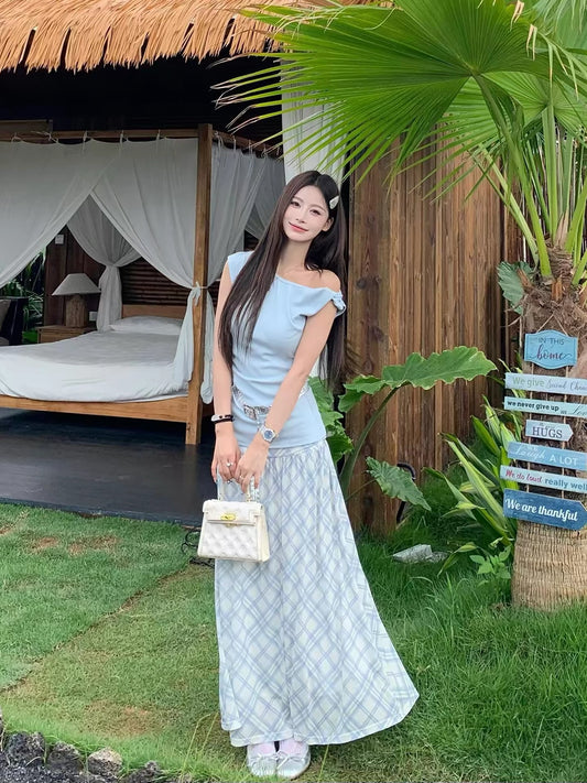 A gentle, Korean-style OOTD outfit set for women, featuring a slim-fitting, off-shoulder top and plaid skirt.