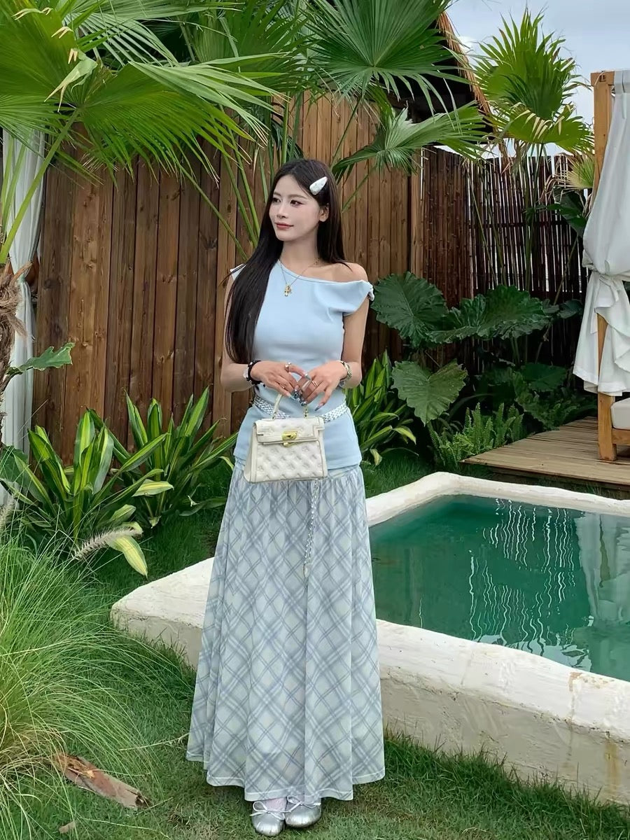 A gentle, Korean-style OOTD outfit set for women, featuring a slim-fitting, off-shoulder top and plaid skirt.