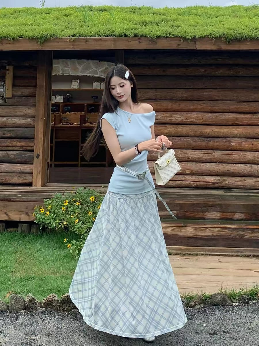A gentle, Korean-style OOTD outfit set for women, featuring a slim-fitting, off-shoulder top and plaid skirt.