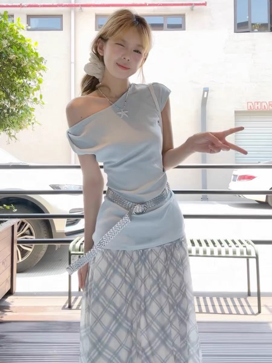Blue fitted off-shoulder short-sleeved t-shirt and high-waisted plaid skirt complete a Korean-style outfit.