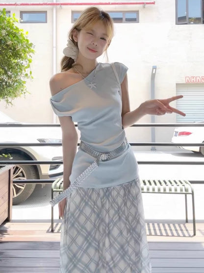 Blue fitted off-shoulder short-sleeved t-shirt and high-waisted plaid skirt complete a Korean-style outfit.