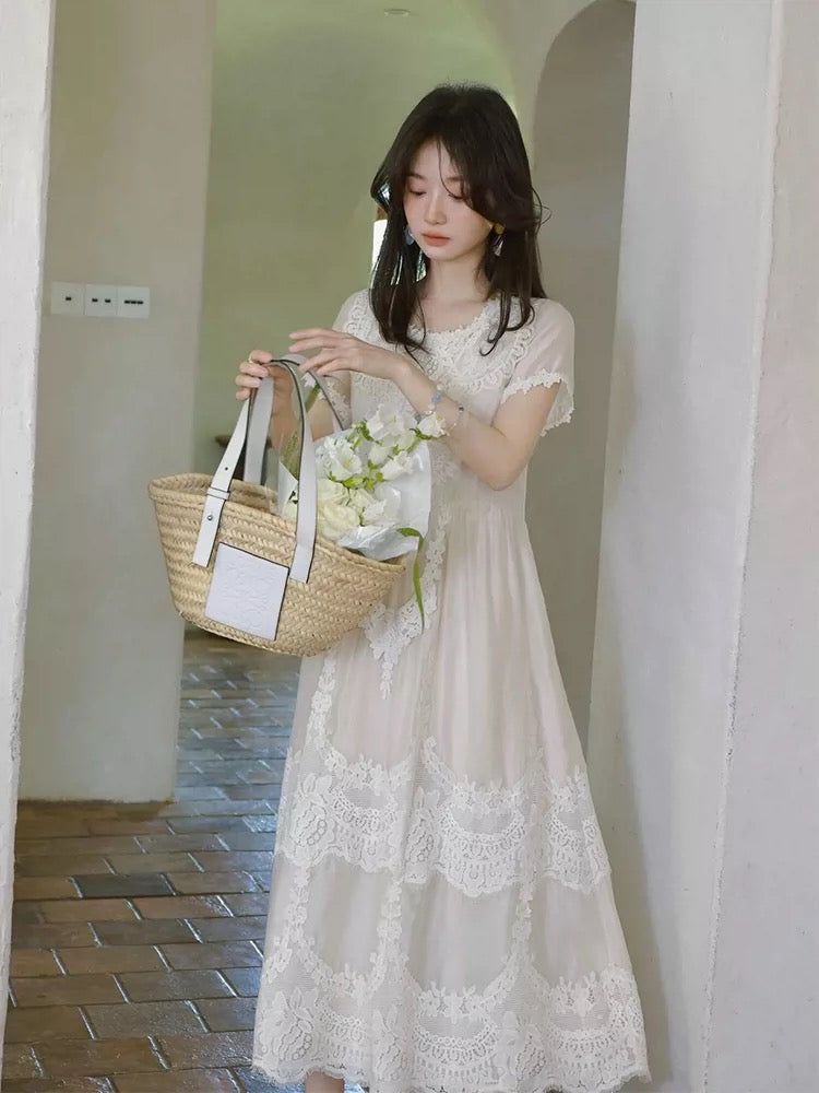 A stunning white lace crochet dress perfect for Spring 2026, exuding a pure, vacation vibe with a unique and beautiful cinched waist.