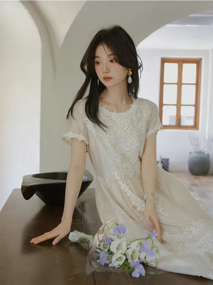 A stunning white lace crochet dress perfect for Spring 2026, exuding a pure, vacation vibe with a unique and beautiful cinched waist.