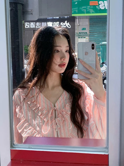 Find the perfect pink ruffled tie-waist long-sleeved shirt for women, a new spring style for 2026, featuring a relaxed, loose French-inspired look.