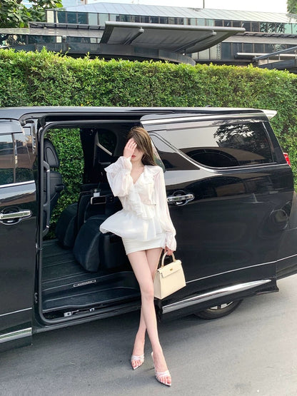 Chill's elegant rosewood runway show featured a deep V-neck ruffled chiffon blouse in a soft white, slightly sheer design.