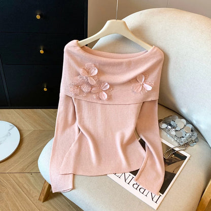A must-have! This long-sleeved knit top with beaded 3D floral details is a sweet and spicy off-shoulder style perfect for autumn.