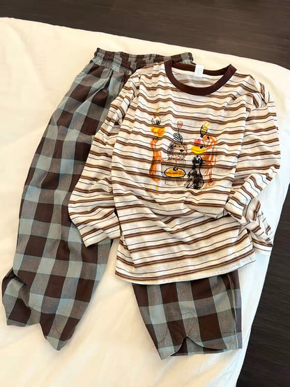 Women's Korean-style loungewear set featuring a striped long-sleeve top with a cartoon print and plaid trousers; a relaxed, laid-back autumn style suitable for wearing both at home and outdoors.