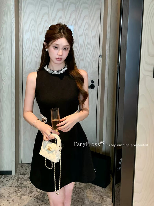 FanyFloss's elegant sleeveless collared sequined waist-cinching dress for summer, a chic French-style little black dress.