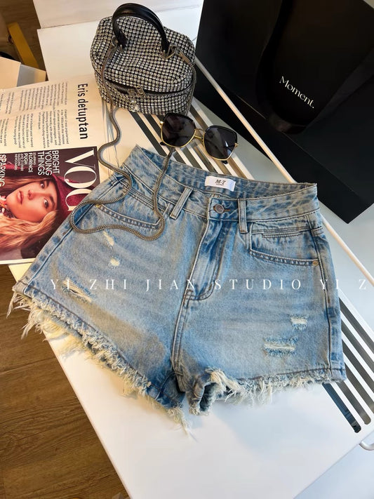 Women's denim shorts with frayed edges, perfect for summer, high-waisted, slimming, A-line, loose fit, trendy and stylish, makes legs look longer.