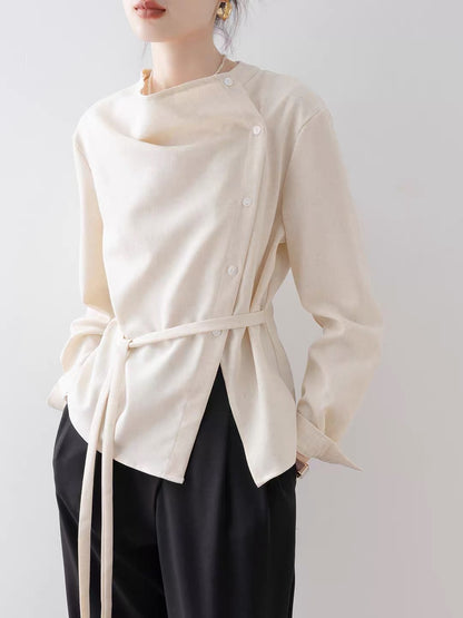 Women's French-style vintage asymmetrical blouse (New for Autumn 2026): an elegant, off-white, waist-cinching shirt featuring a draped neckline.