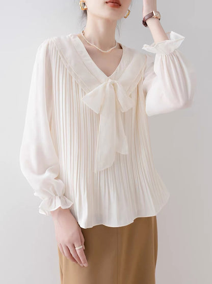 Women's French-style apricot V-neck long-sleeve shirt (New for Autumn 2026): Loose-fitting blouse featuring a stylish bow design.