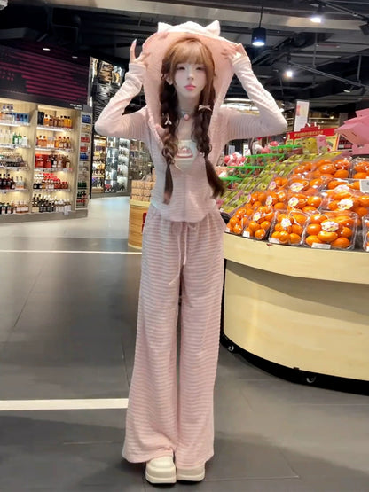 A sweet and spicy two-piece set in pink, featuring a fitted sweatshirt, cardigan, and wide-leg pants, perfect for early autumn and a sporty look.