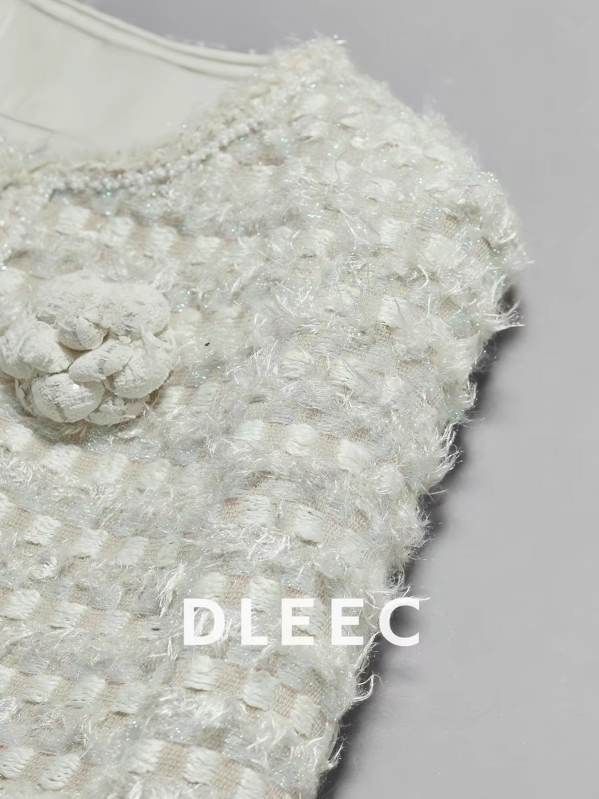 DLEEC – Unique and distinctive! A "-style" jacket in a creamy apricot hue, featuring a textured, iridescent plaid pattern.