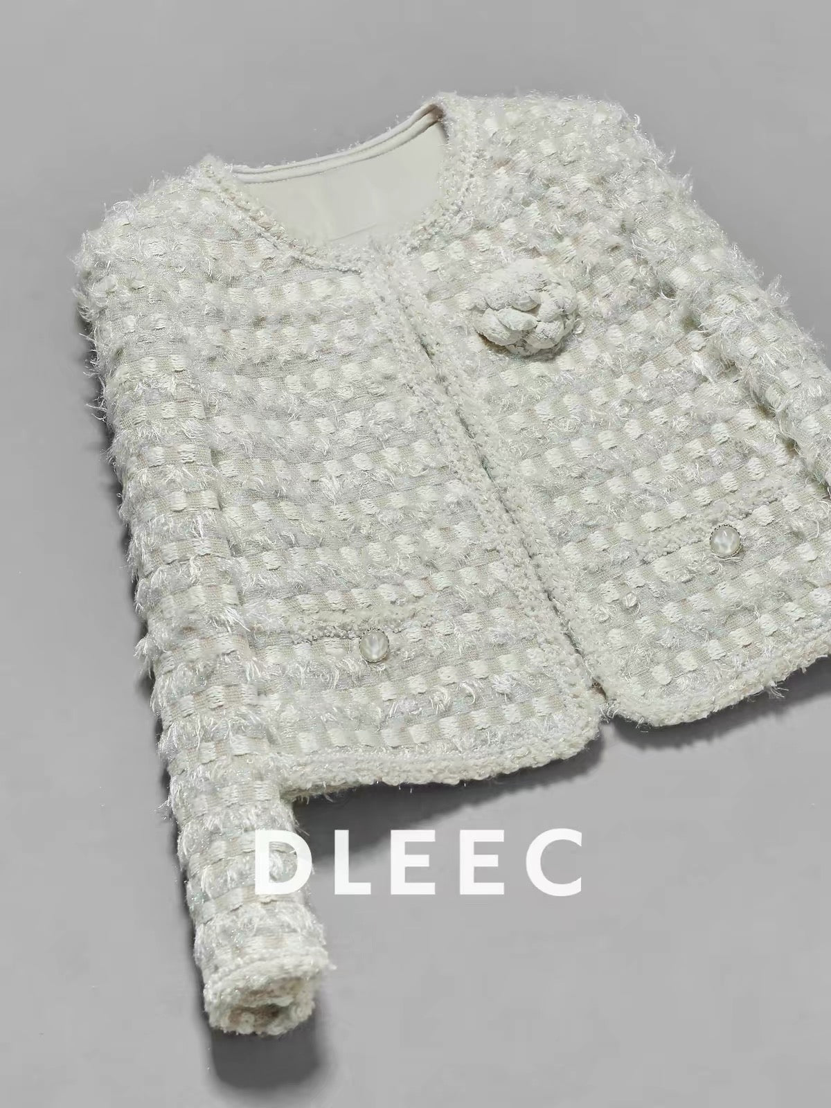 DLEEC – Unique and distinctive! A "-style" jacket in a creamy apricot hue, featuring a textured, iridescent plaid pattern.