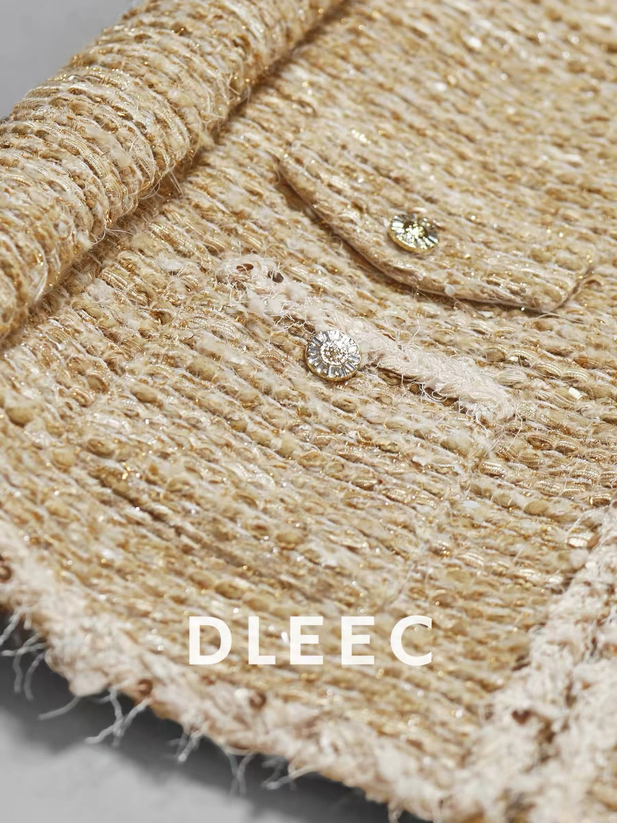 DLEEC Mid-length "-style" jacket featuring a premium, understated-luxury design with metallic thread, sequins, and sheer detailing—an elegant, figure-flattering top.