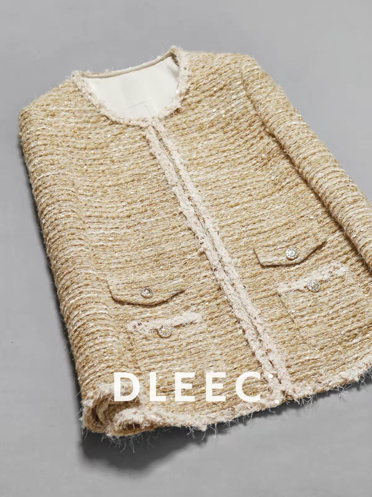DLEEC Mid-length "-style" jacket featuring a premium, understated-luxury design with metallic thread, sequins, and sheer detailing—an elegant, figure-flattering top.