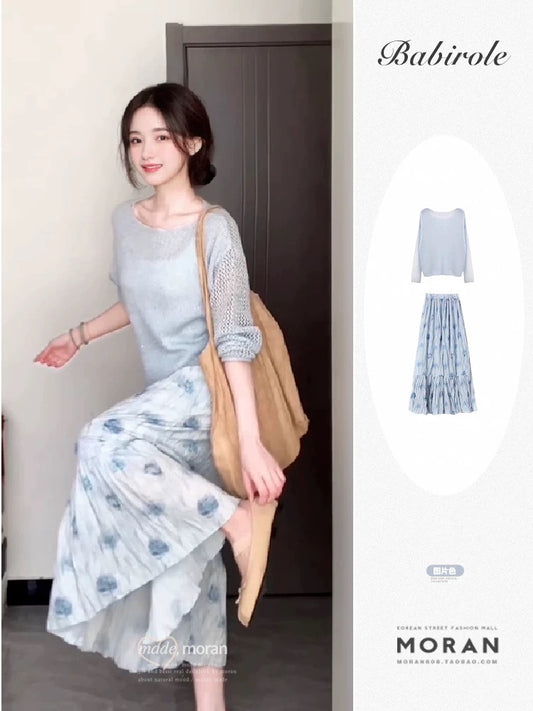 A soft and gentle knitted cardigan and blue floral print midi skirt set for early autumn, exuding elegance.