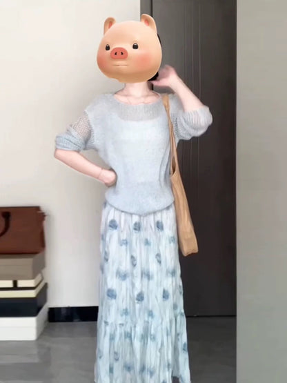 A soft and gentle knitted cardigan and blue floral print midi skirt set for early autumn, exuding elegance.