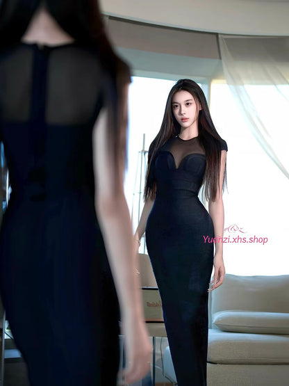 YUANZI "Black Iris" – Black bodycon maxi dress featuring spliced mesh panels and integrated strap detailing.