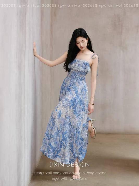 Send a letter featuring a gentle, blue and white floral print sundress with a cinched waist, a flattering and slimming Tencel linen dress.