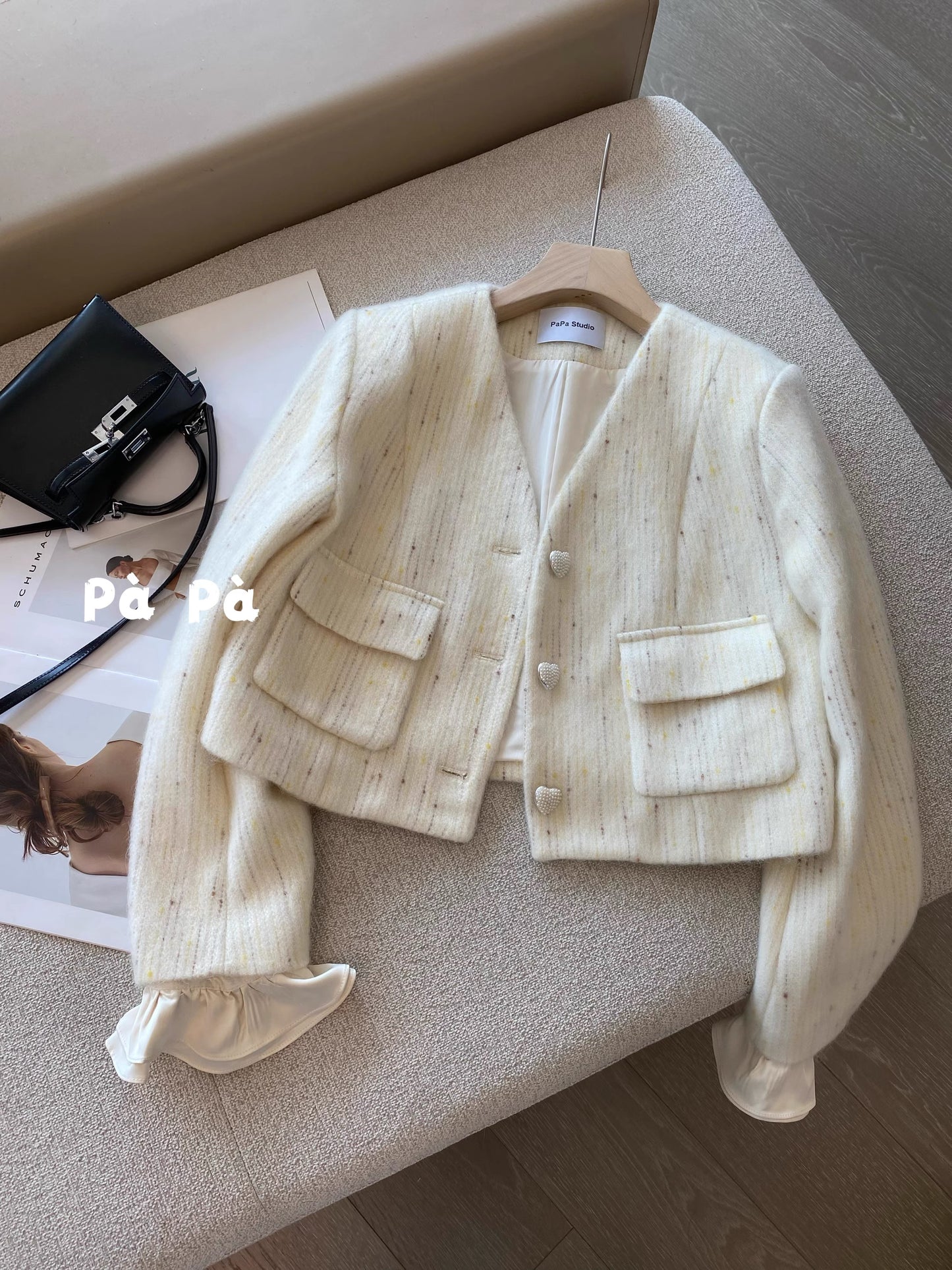 Exquisite and luxurious wool knit cardigan with heart-shaped buttons and detachable ruffled sleeves, featuring a V-neck design.
