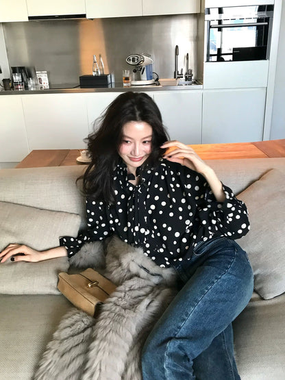 Long Xier, a niche design, featuring a gentle polka dot print lace shirt with a flowing collar, perfect for wearing outside. J380