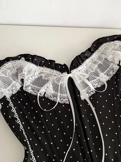 French-style court-inspired top for women, featuring lace trim, sleeveless strapless design, and a fitted boning polka dot pattern.
