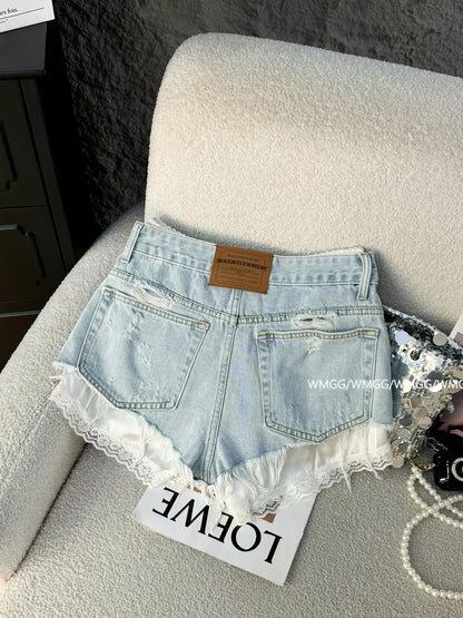 Light blue denim shorts for women, super trendy in 2026, featuring ripped details, patchwork lace trim, and sexy hot pants.