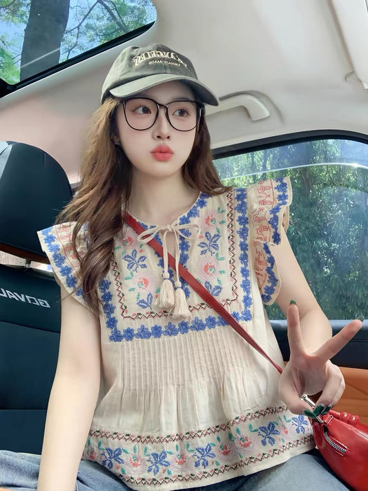 Apricot-colored ethnic-style short-sleeved shirt with flutter sleeves and a straight shoulder, a new summer style for 2026, featuring a unique and sophisticated design.