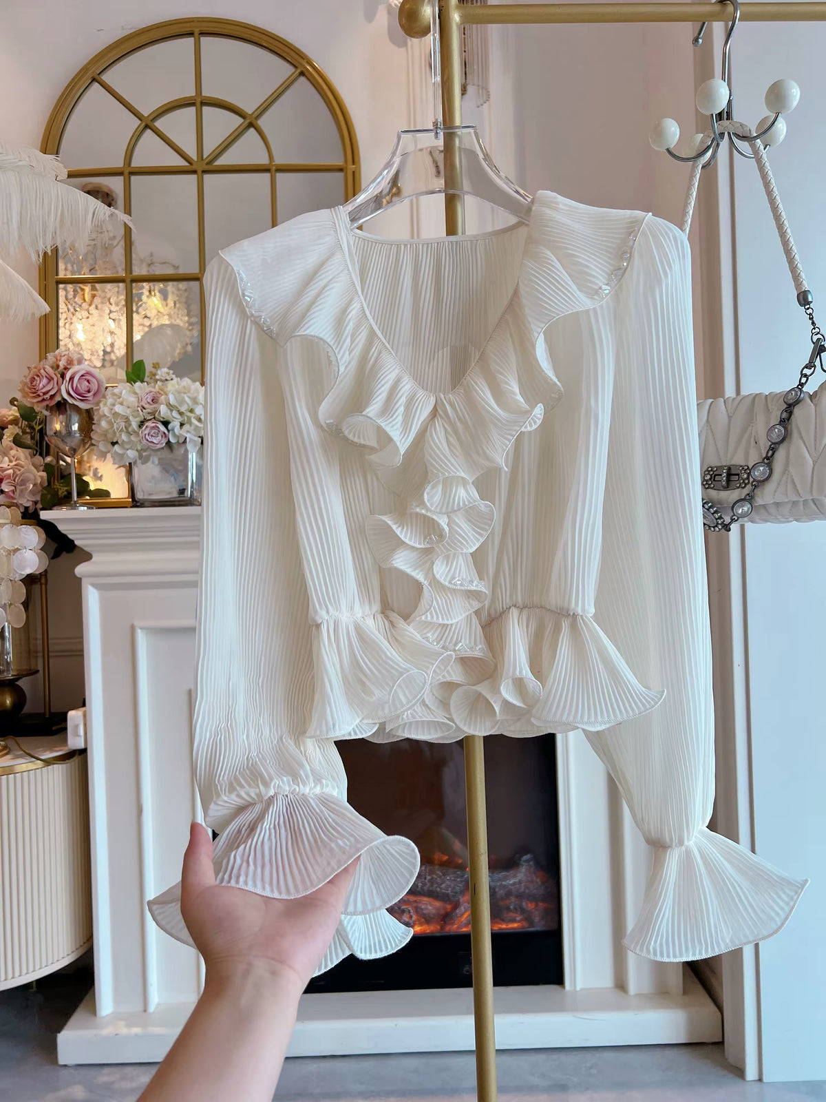 Women's Autumn 2026 French-style cropped chiffon blouse featuring a V-neck, ruffled details, textured pleats, flared sleeves, and a fitted waist.