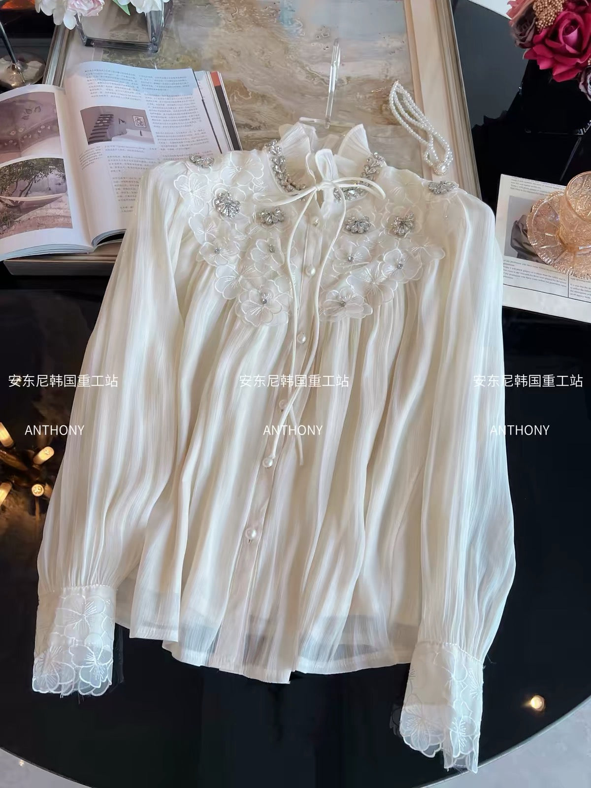 Trendy Korean-style loose-fit chiffon blouse featuring intricate rhinestone embellishments, 3D petal details, a single-breasted front, and long sleeves.